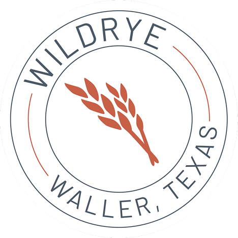 Circular logo with a wheat stalk and the text Wildrye Waller TX, ideal for new construction homes.
