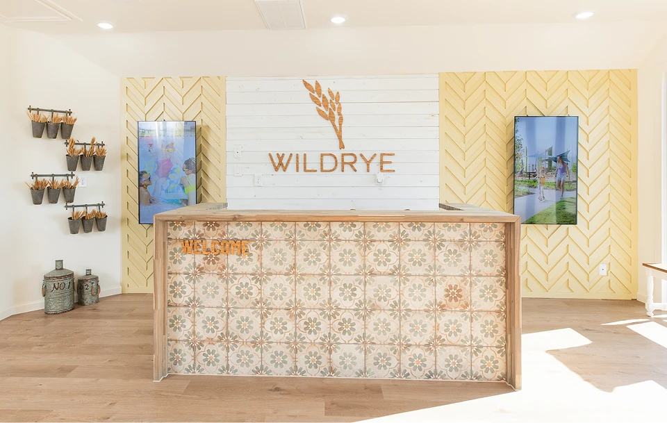 Reception desk with patterned tiles at Wildrye, welcoming guests to new homes in Waller TX.