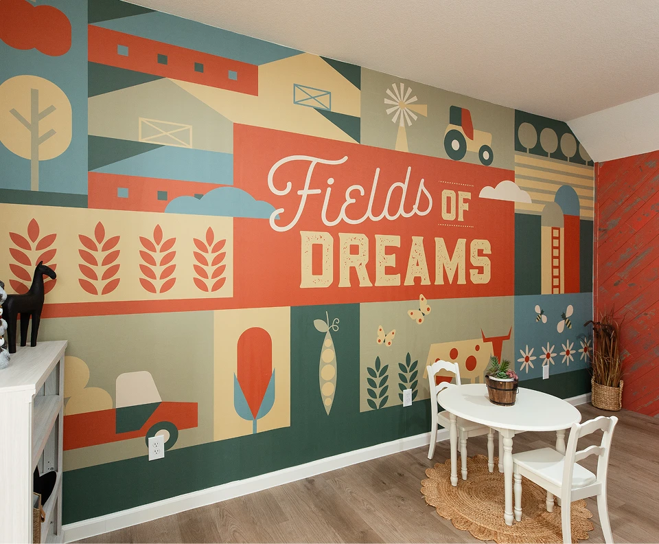 Children’s playroom in Wildrye, Waller TX, with a colorful Fields of Dreams farm-themed mural.